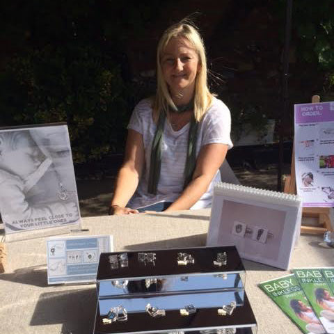 business owner at sales event with fingreprint jewellery