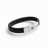 Memorial ashes captured in a pawprint on a braided black leather bracelet