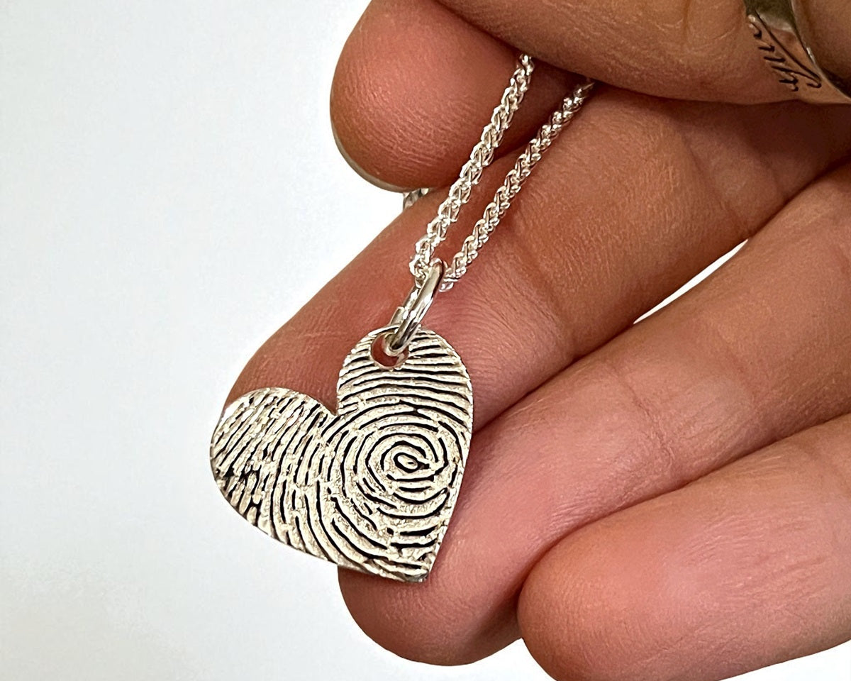 Heart-shaped fingerprint pendant on a chain