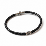 Black braided leather bracelet with silver clasp on a white background