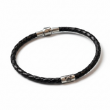 Black braided leather bracelet with silver clasp on a white background