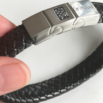Memorial ashes captured on a braided black leather bracelet