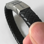 Memorial ashes captured on a braided black leather bracelet
