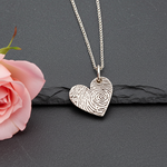 Heart-shaped fingerprint pendant on a chain