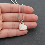 Heart-shaped fingerprint pendant on a chain