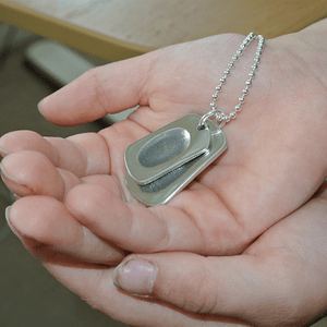 baby holding Fingerprint Dogtag Necklace