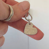 Heart-shaped fingerprint pendant on a chain