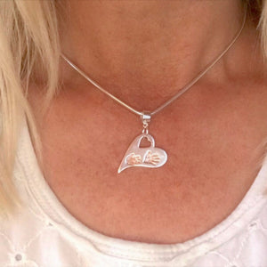 Lady wearing Wavy Heart Two Handprints with Rose Gold. Sterling Silver Handprint Jewellery